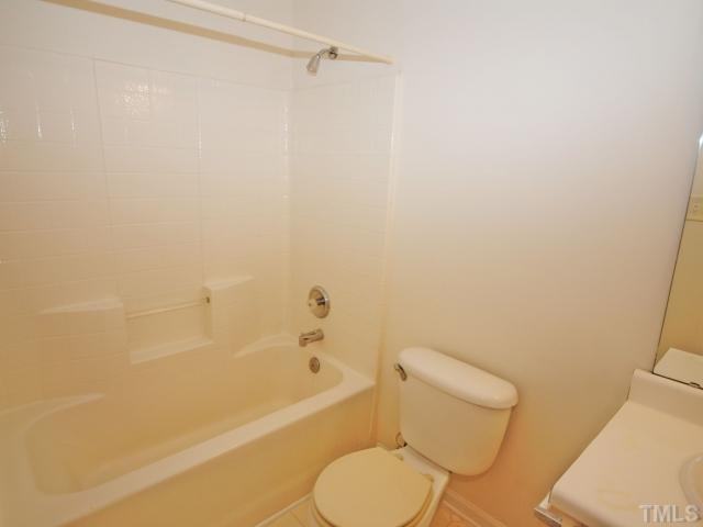4709 Silverdene Street Raleigh, NC 27616 - Photo 11 of 15 a white toilet and tub next to a bathroom sink