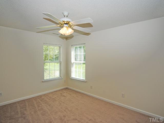 4709 Silverdene Street Raleigh, NC 27616 - Photo 13 of 15 an empty room with windows and fan