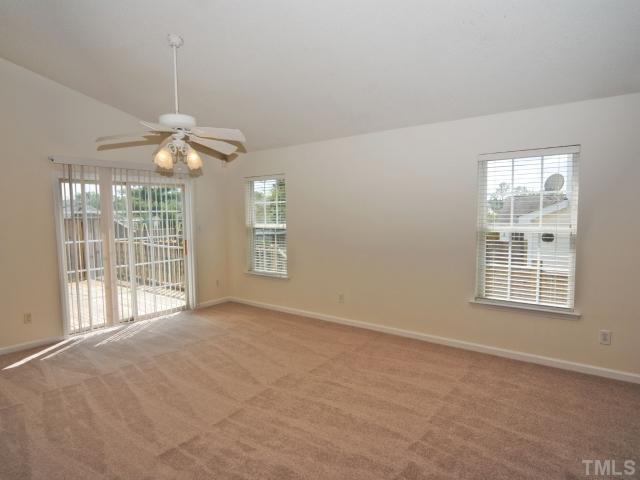 4709 Silverdene Street Raleigh, NC 27616 - Photo 8 of 15 an empty room with chandelier fan and windows