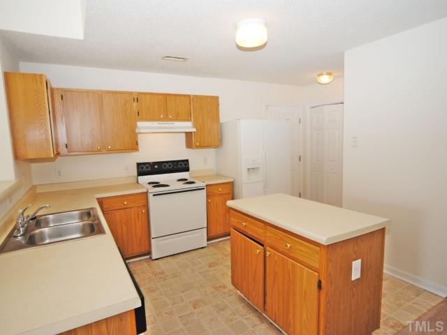 4709 Silverdene Street Raleigh, NC 27616 - Photo 9 of 15 a kitchen that has a sink and a stove