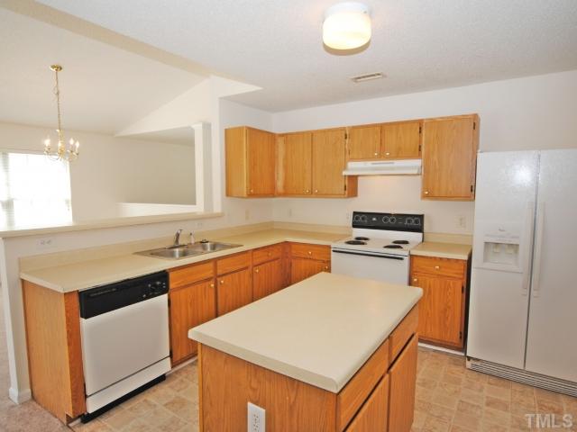4709 Silverdene Street Raleigh, NC 27616 - Photo 10 of 15 a kitchen with a stove a sink and a refrigerator