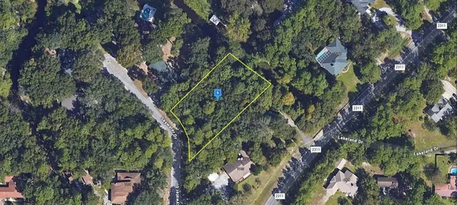 a backyard of a house with lots of trees