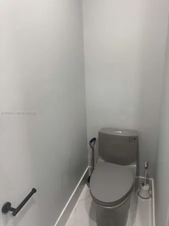 a white toilet sitting next to a white sink