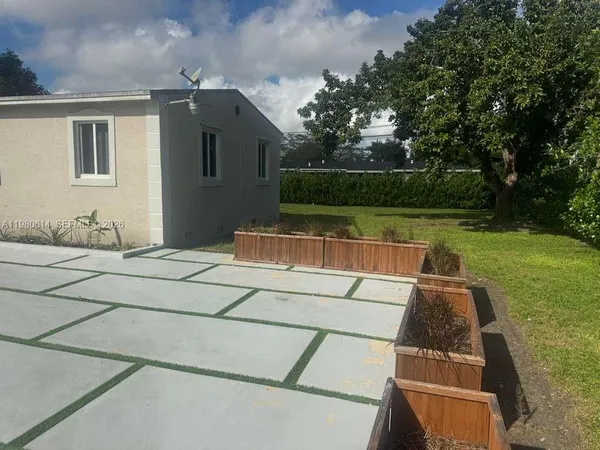 a view of a balcony with two chairs and a table