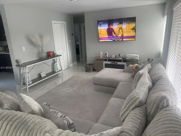 a living room with furniture and a flat screen tv