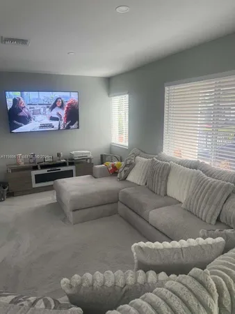a living room with furniture and a large window