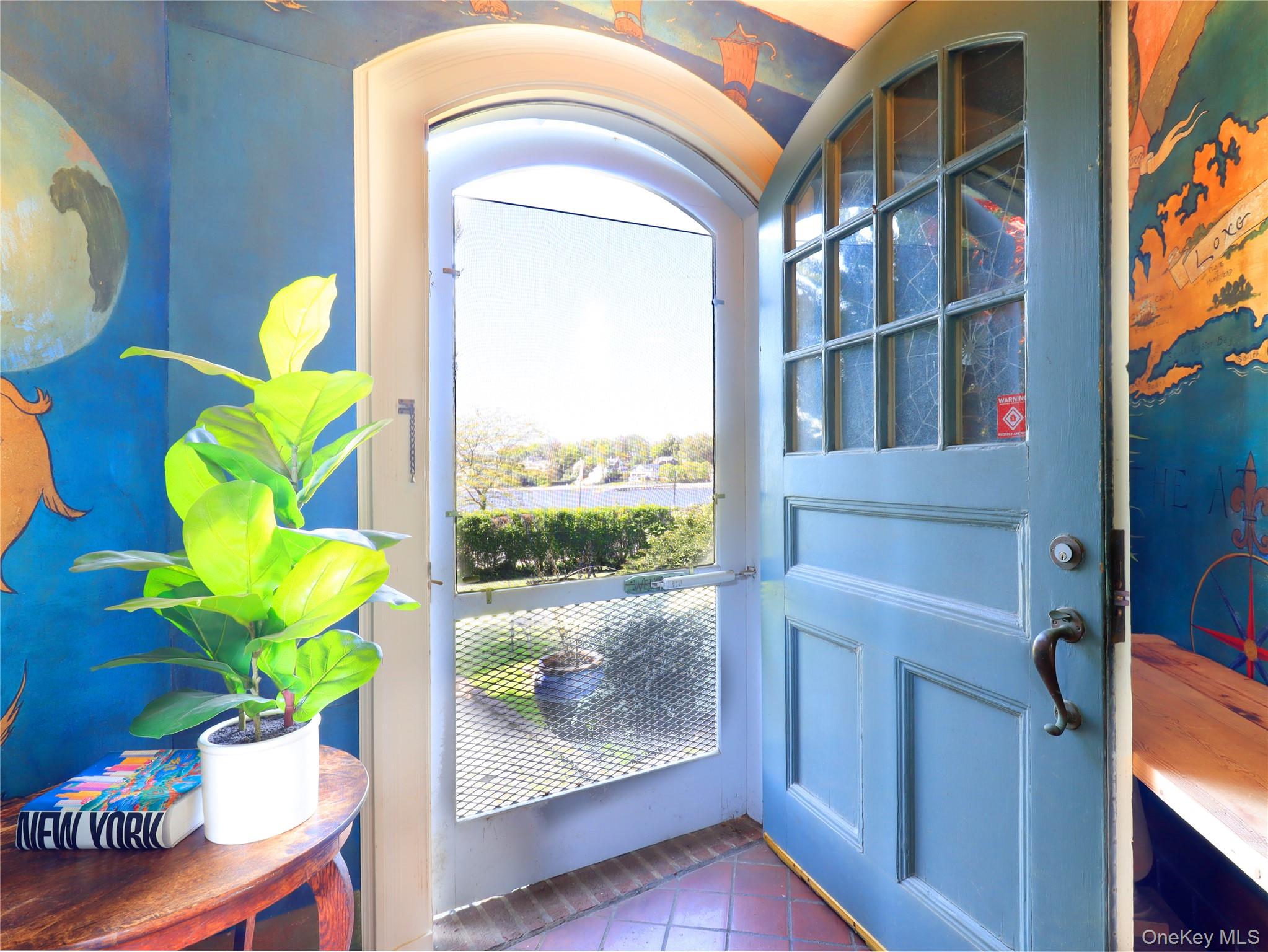 11-20 Shore Road Queens, NY 11363 - Photo 22 of 45 Arched entry door with glass panels and substantial hardware