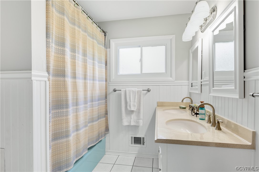 9117 Mapleview Avenue Henrico, VA 23294 - Photo 8 of 21 a bathroom with a sink a vanity and a shower