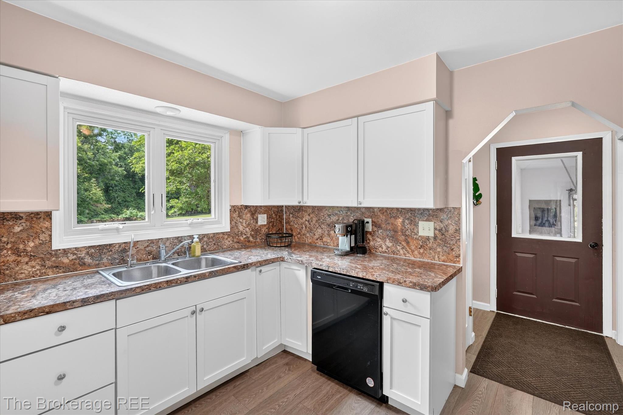 13269 North Genesee Road Clio, MI 48420 - Photo 17 of 67 Kitchen featuring white cabinetry, a double basin stainless steel sink, wood-finish flooring, and a black built-in dishwasher