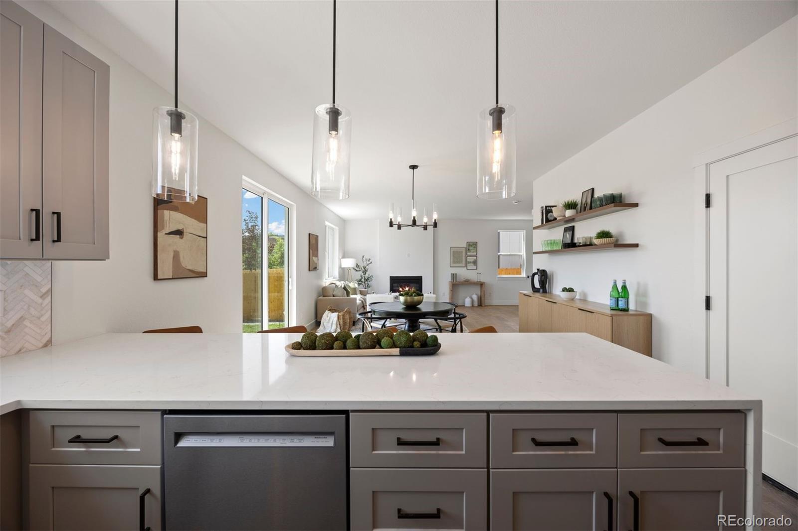 4026 Upham Street Wheat Ridge, CO 80033 - Photo 12 of 50 a kitchen with kitchen island a counter space a sink and appliances