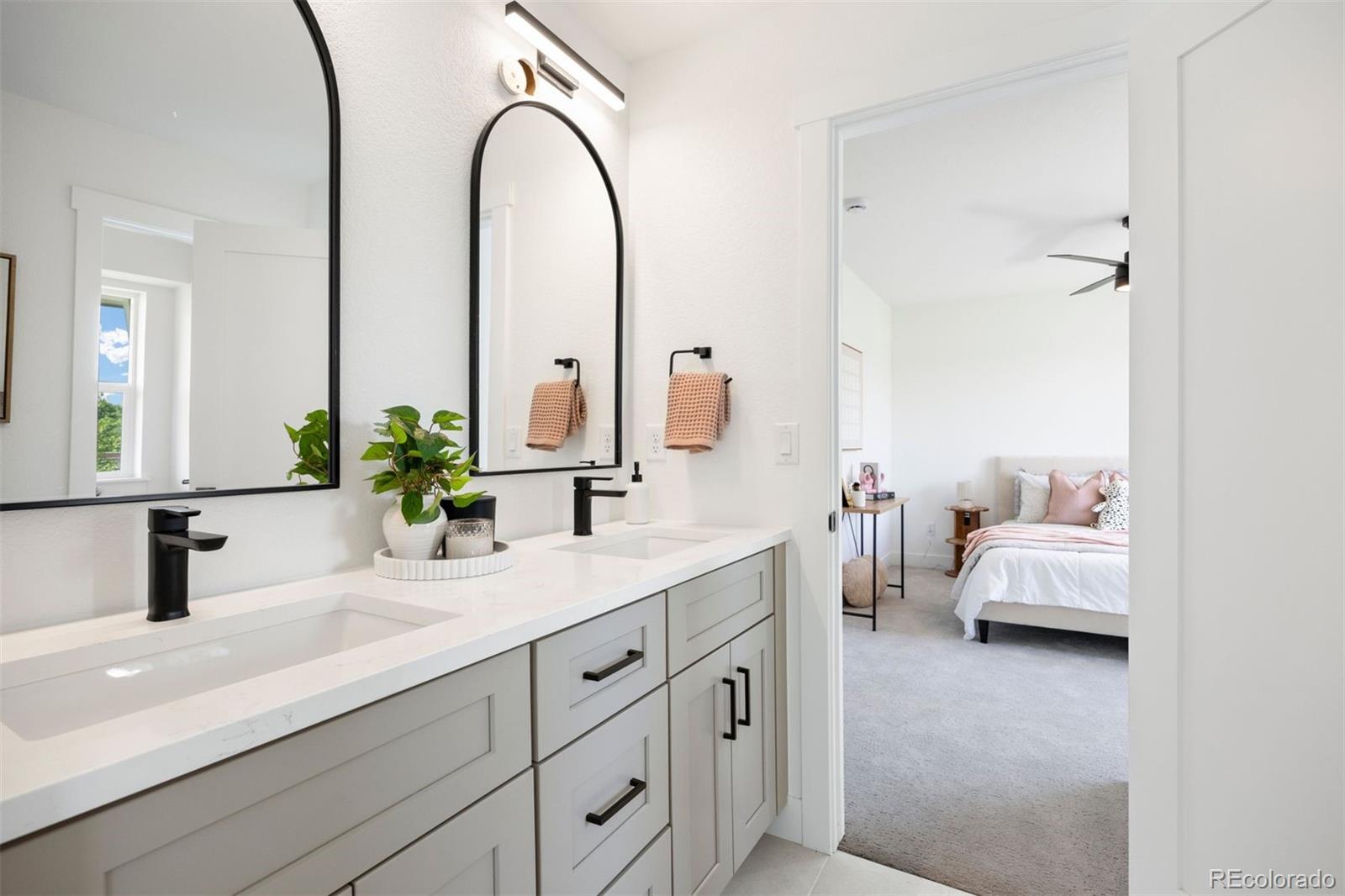 4026 Upham Street Wheat Ridge, CO 80033 - Photo 34 of 50 a en suite bathroom with double sink and a mirror