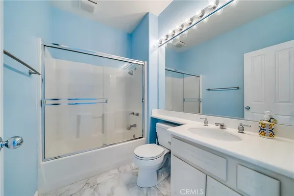 a bathroom with a toilet a sink and shower