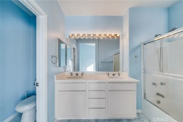 a view of bathroom with a sink and mirror