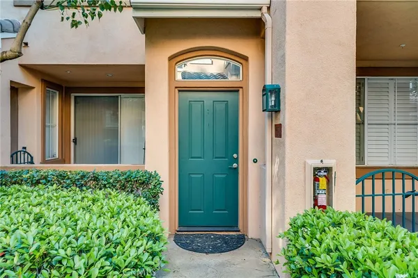 a view of staircase with white walls and white door
