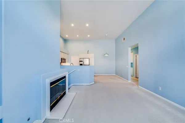 a kitchen with a refrigerator and a stove top oven