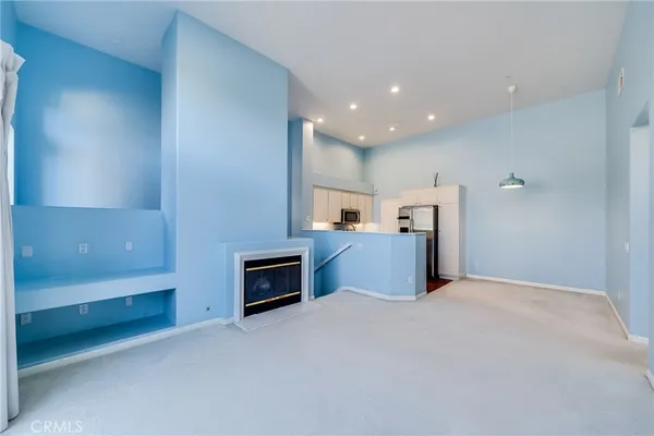 a kitchen with a refrigerator and a stove top oven