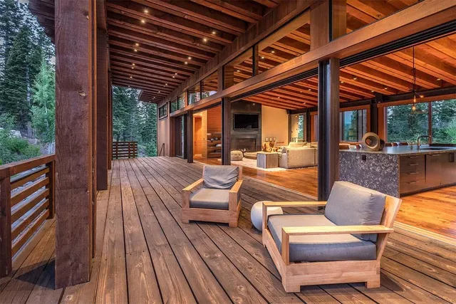 a living room with furniture and large windows