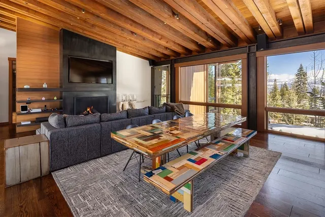 a kitchen with a table chairs and a wooden floor