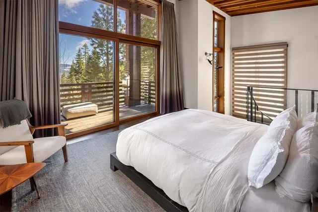 a spacious bathroom with a double vanity sink a large mirror and a bathtub