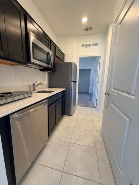 352 Kayden Cove Lake Wales, FL 33859 - Photo 14 of 32 a kitchen with stainless steel appliances granite countertop a refrigerator and a stove top oven