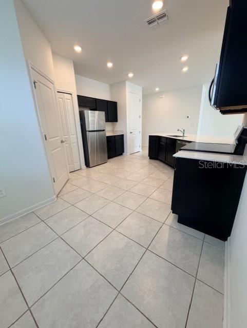 352 Kayden Cove Lake Wales, FL 33859 - Photo 19 of 32 a kitchen with stainless steel appliances granite countertop a stove a refrigerator a sink and a microwave