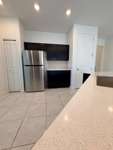 352 Kayden Cove Lake Wales, FL 33859 - Photo 23 of 32 a kitchen with a refrigerator and a stove top oven