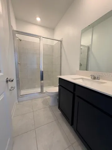 a bathroom with a sink a mirror and a shower