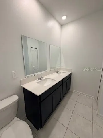 a bathroom with a sink a toilet and mirror