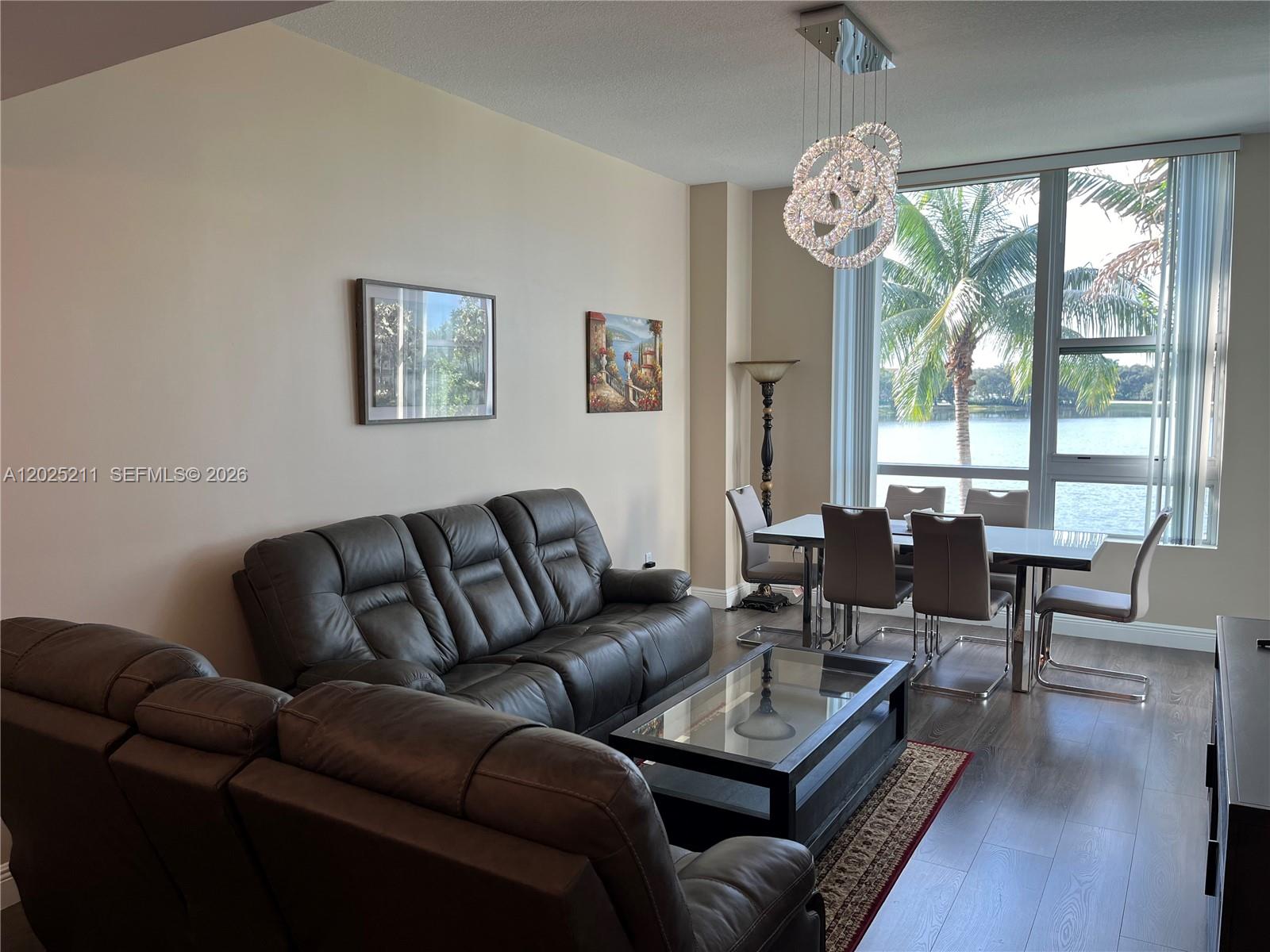 2681 North Flamingo Road, Unit 303S Sunrise, FL 33323 - Photo 5 of 18 a living room with furniture a large window and wooden floor