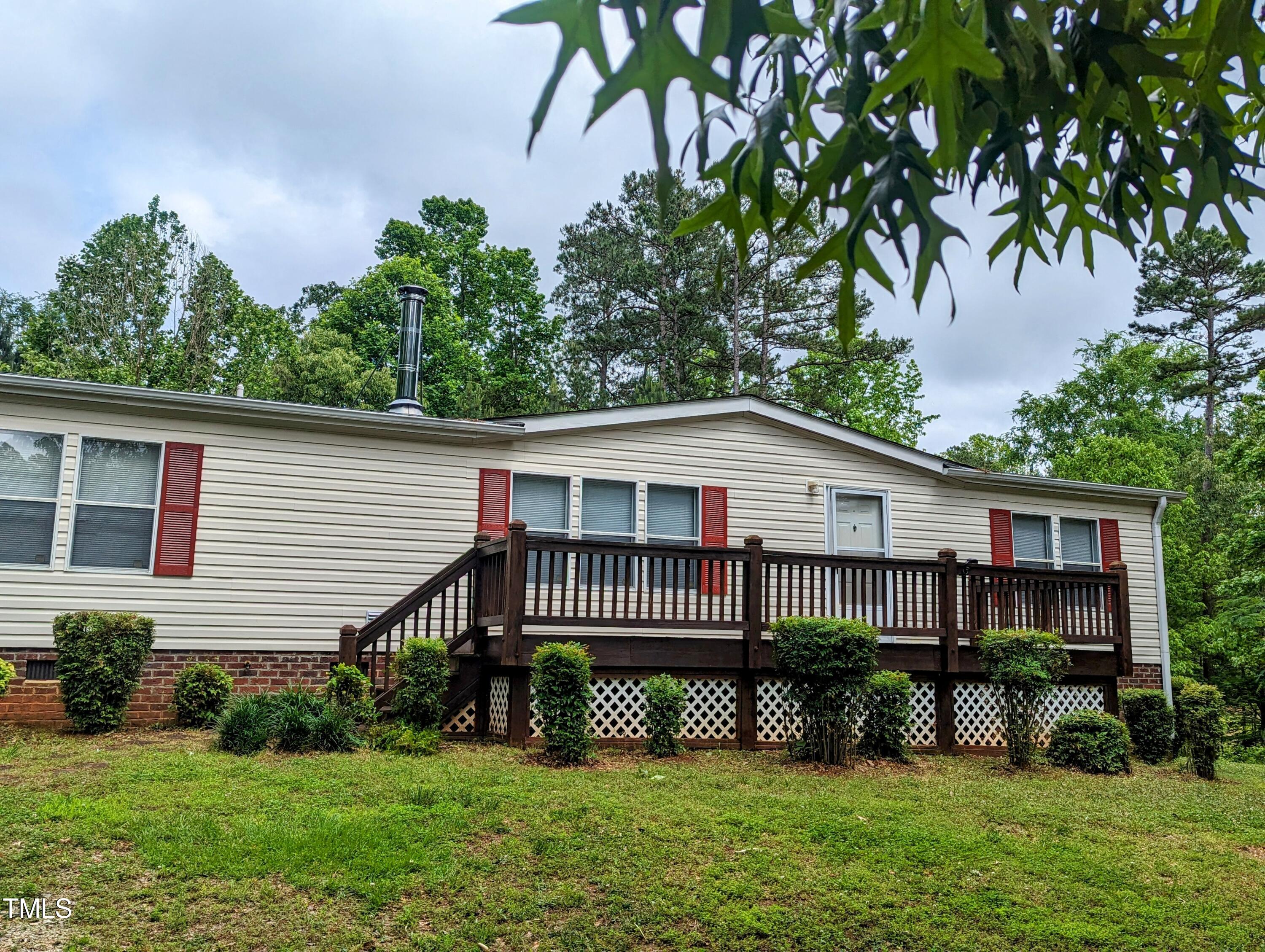 271 Buoy Drive Henderson, NC 27537 - Photo 1 of 21 a front view of a house with a garden