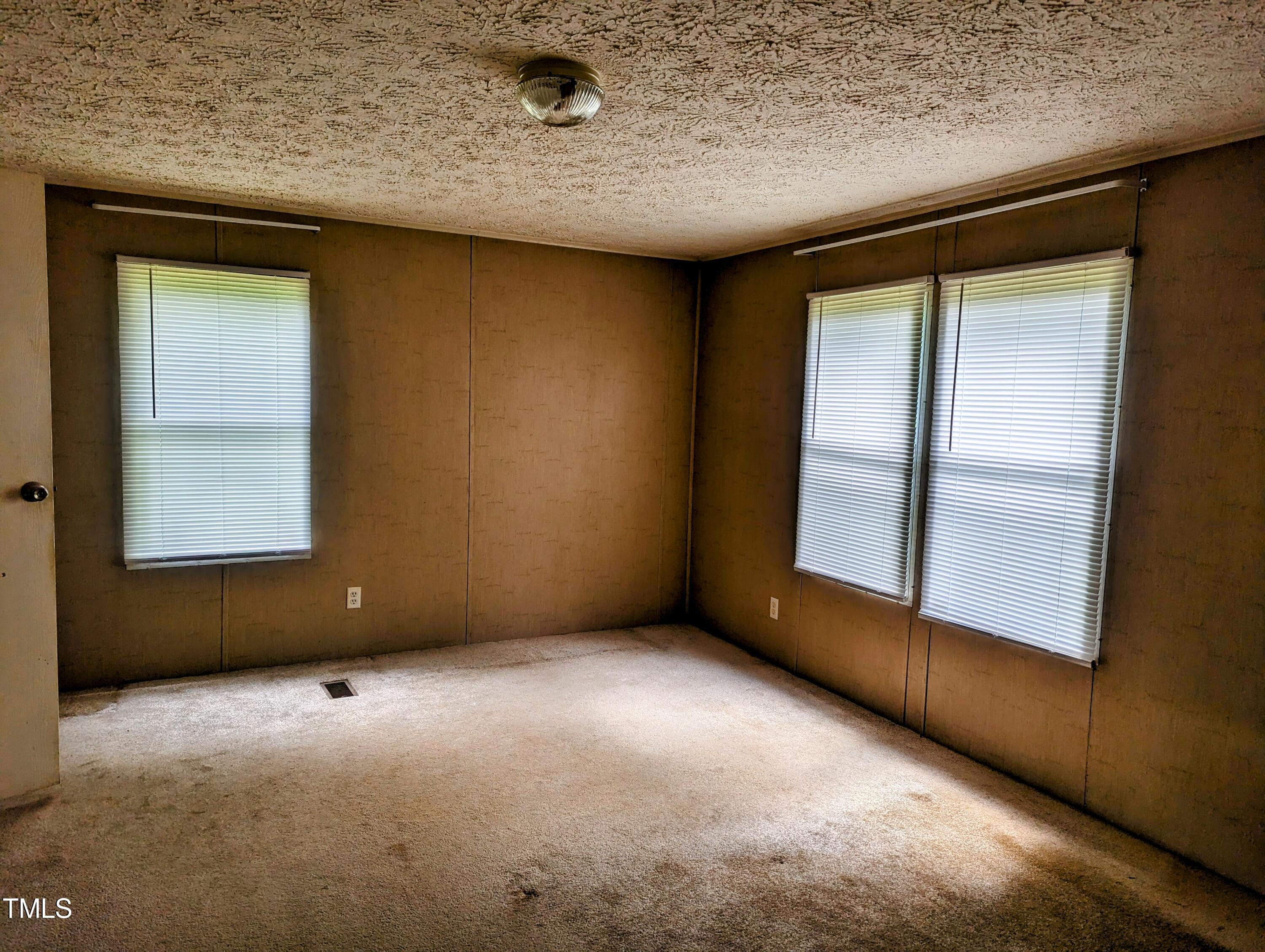 271 Buoy Drive Henderson, NC 27537 - Photo 15 of 21 an empty room with windows