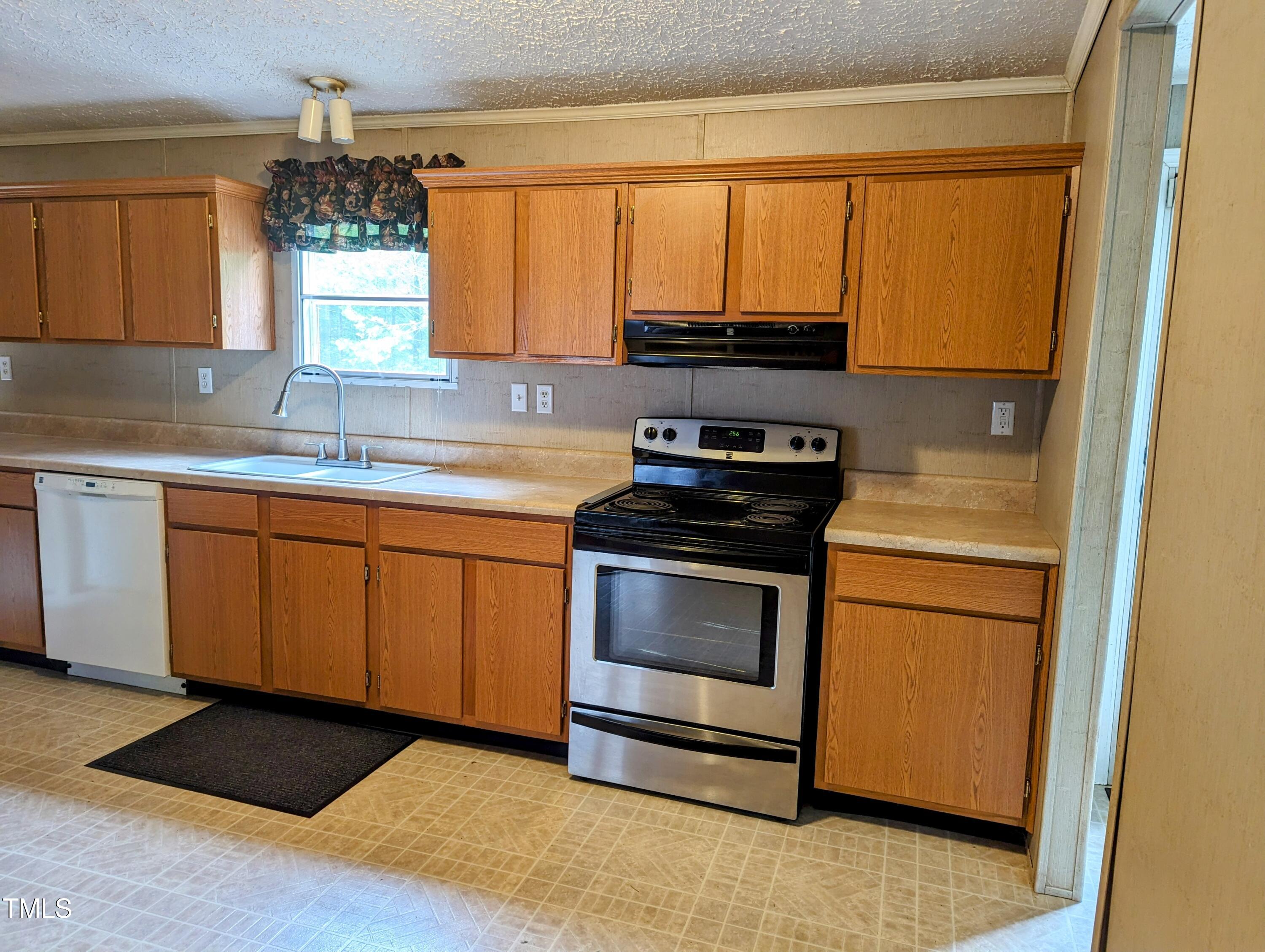 271 Buoy Drive Henderson, NC 27537 - Photo 9 of 21 a kitchen with a stove a sink and a microwave