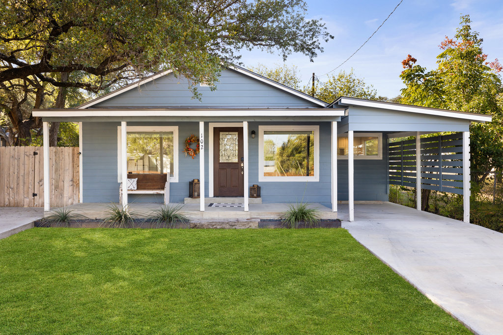 a view of a house with a yard and garden
