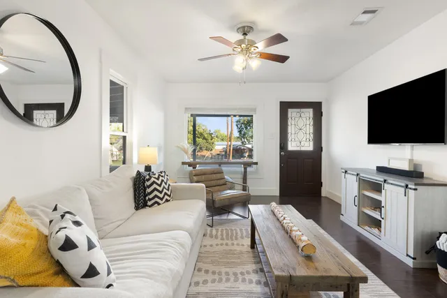 a living room with furniture and a flat screen tv