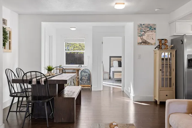a view of a a dining room with furniture window and wooden floor