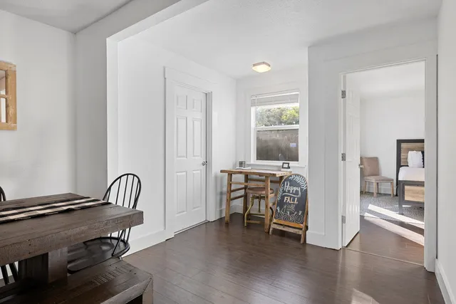 a view of a workspace with furniture and wooden floor