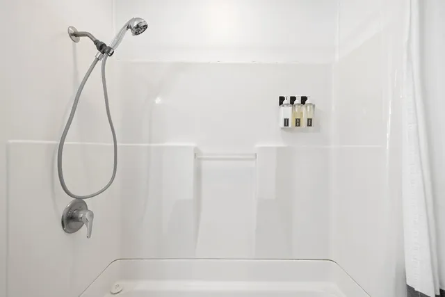 a bedroom with a bed and table chair