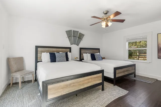 a bedroom with a large bed and a chandelier