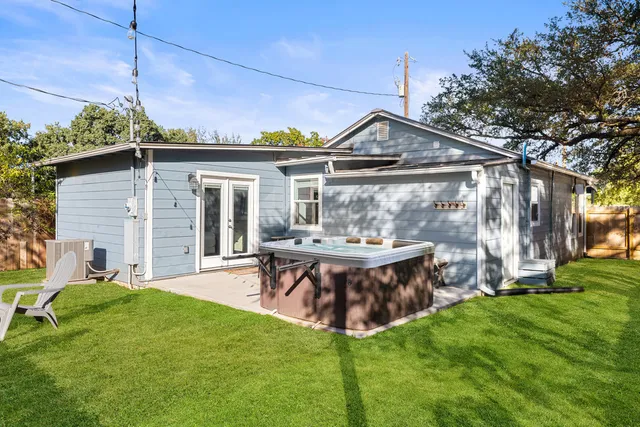 a view of a chair and table in backyard of the house