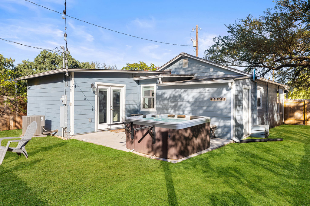 102 Ranchview Drive Johnson City, TX 78636 - Photo 33 of 37 a view of a backyard with table and chairs potted plants and large tree