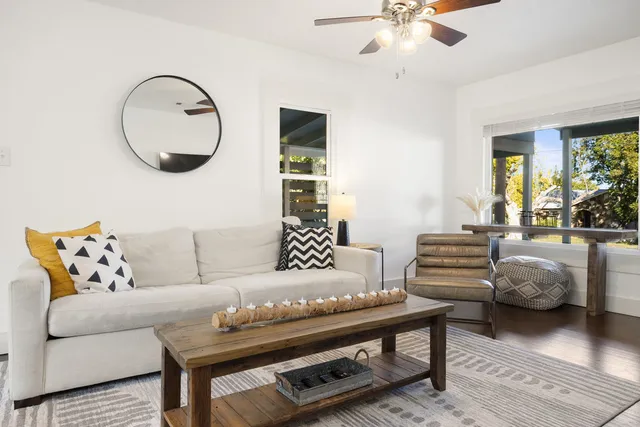 a living room with furniture and a large mirror