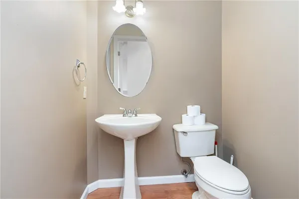 a bathroom with a toilet a sink and a mirror
