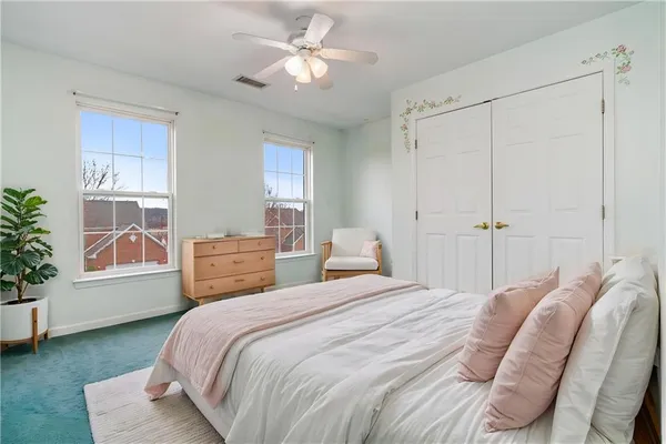 a bedroom with a large bed and a window