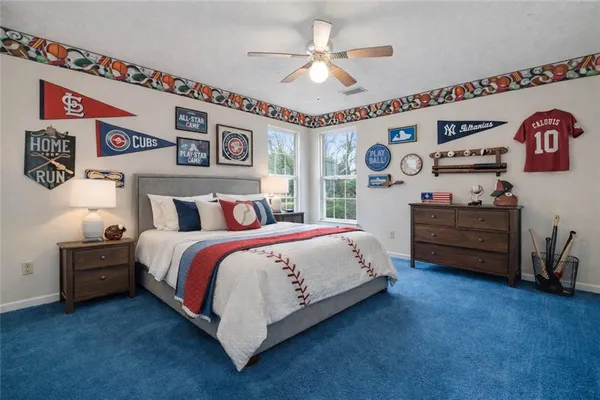 a spacious bedroom with a bed and a chandelier