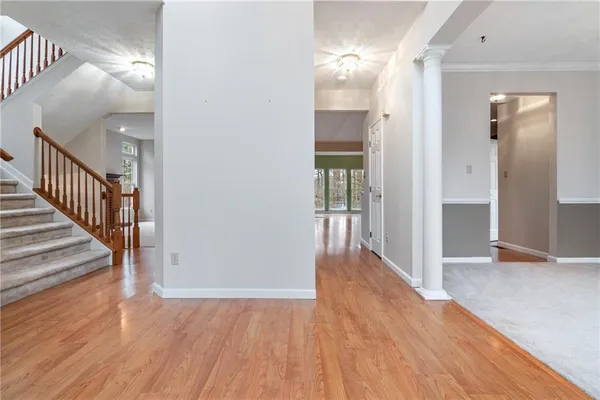 a view of a hallway with wooden floor