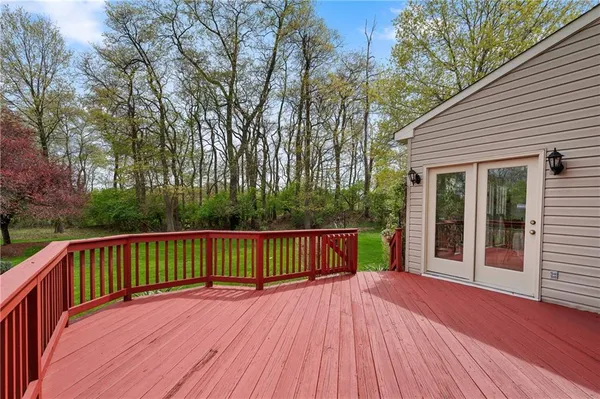 a view of a house with a wooden deck
