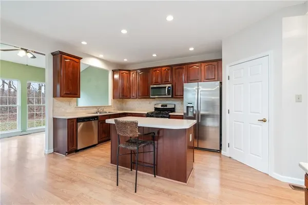 a kitchen with a sink cabinets and wooden floor