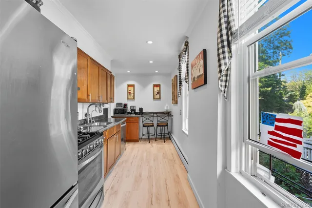 a kitchen with stainless steel appliances granite countertop a refrigerator and a stove top oven