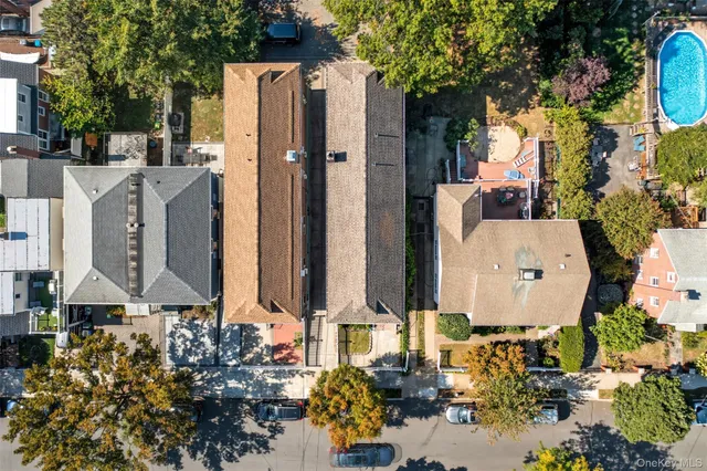 a aerial view of a house with a yard and large trees
