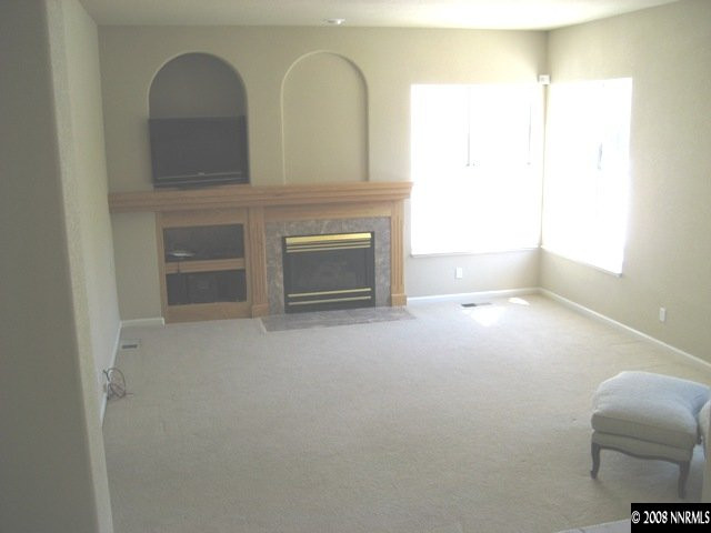 4723 Village Reno, NV 89519 - Photo 2 of 9 a living room with furniture and a fireplace